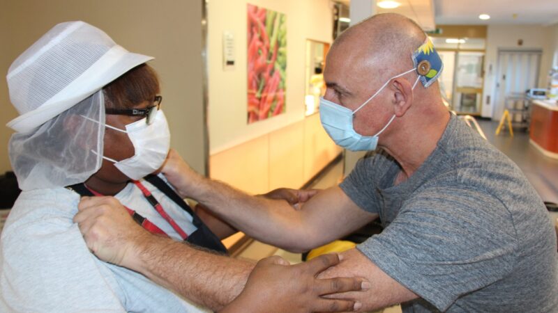 David Brereton grabs Marlene Sweeney by the shoulders. Marlene wears a catering uniform.