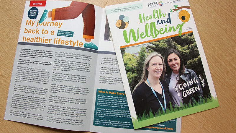 Health and wellbeing magazine laid out on table.