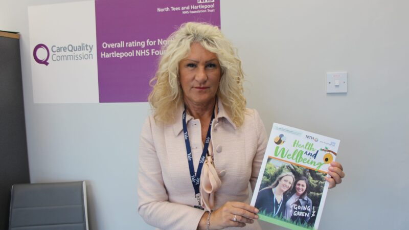 Julie Gillon holding Health and Wellbeing magazine