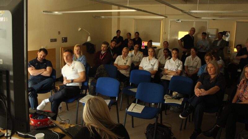 Staff watch the surgery live stream