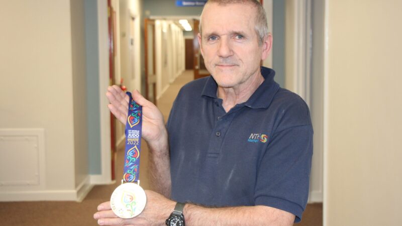 Porter David Francis with his son's International Judo Federation World Masters silver medal.