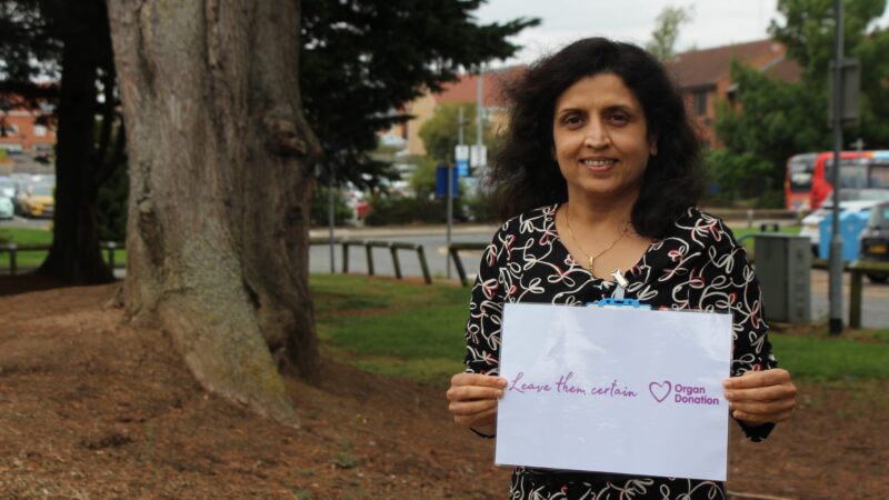 Dr Tara Mane holding sign that reads 'Leave them certain'