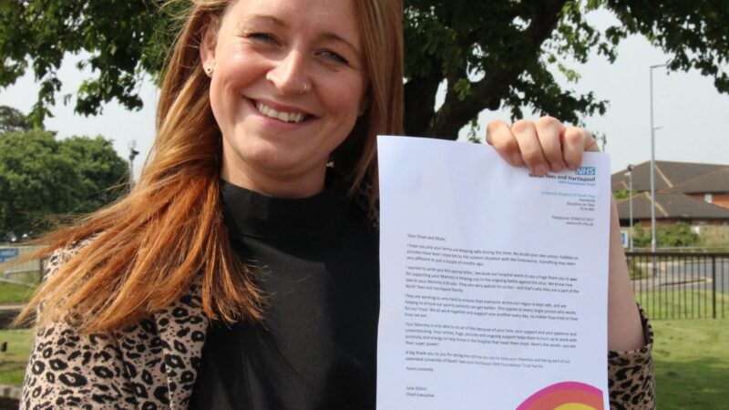 Colleague Kara Pickering with super power letter from Chief Executive