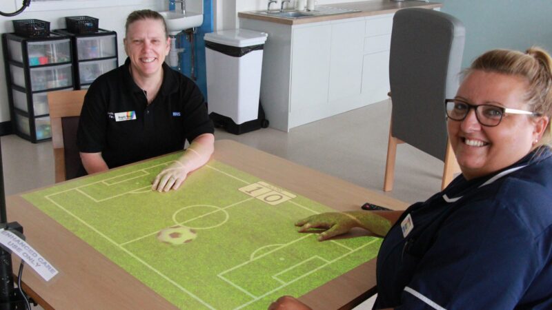 Angela Reeve and Nicola Murphy at a magic light table in the enhanced care room.