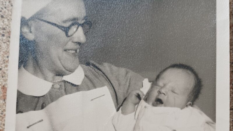 1956 black and white photo of Lilian Richards holding a baby.