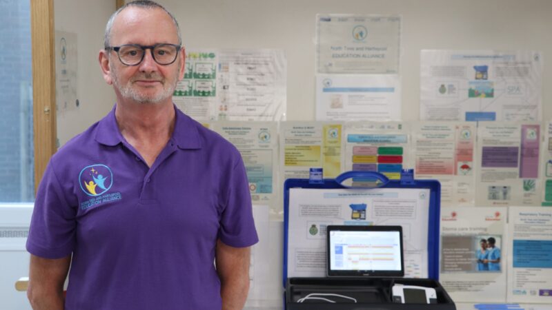 Andy Cotton stands with training kit.
