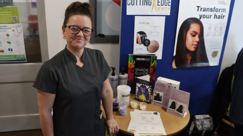An exhibitor at her 'Cutting Edge @NTH' stand. She has free sample of shampoos.