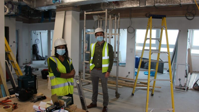 Vandana Jeebun and Jordan Pearson stand in the worksite.