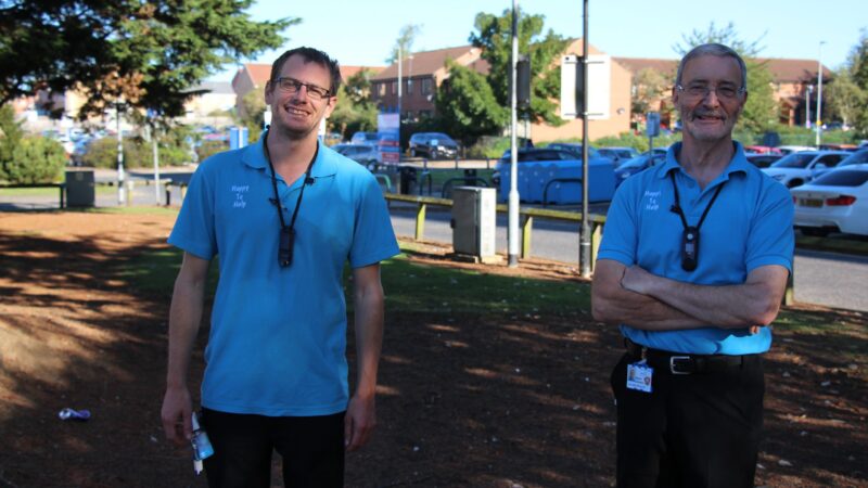 James and Wayne stand outside.