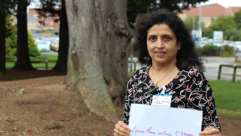 Tara Mane holds a sign which reads: "Leave them certain".