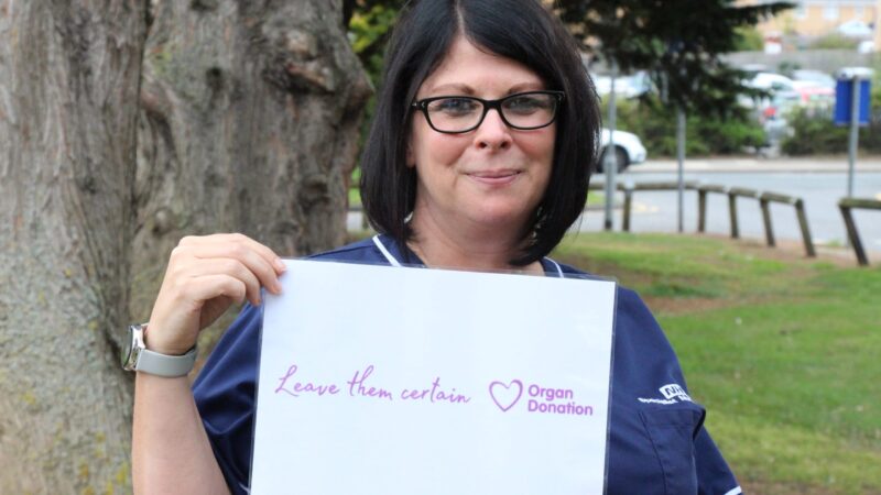 Janine Tate holds a sign which reads: "Leave them certain".