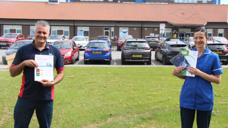 Staff stand outside the University Hospital of North Tees. They hold documents about learning disability.