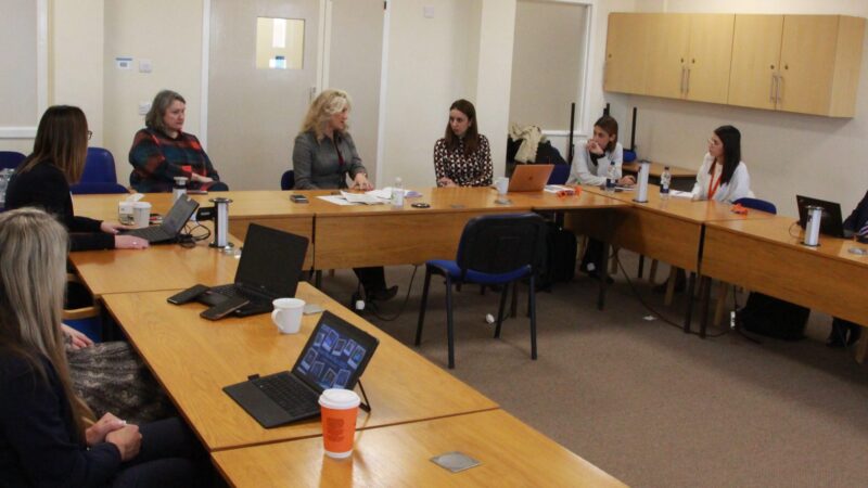 Visitors talk with Jill Mortimer and Julie Gillon.
