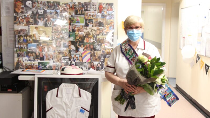 Kathy McIntosh holds a bouquet of flowers.