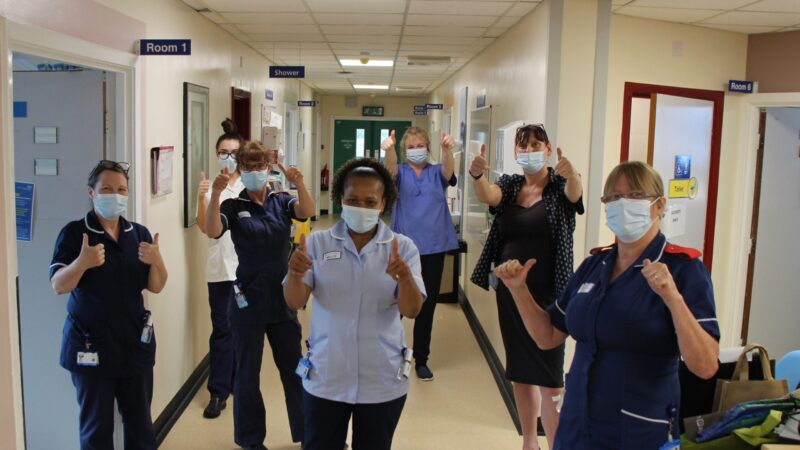 Critical care staff give a thumbs up.
