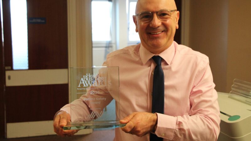 Graham Evans holds a glass award.
