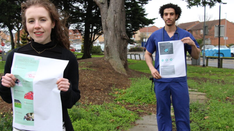 Kirsty Grant and Omar Ahmed hold their posters.