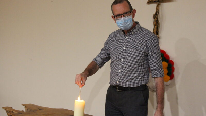 Jim Wright lighting a candle.